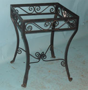 Small square side table with hand forged scrolls and splayed feet
